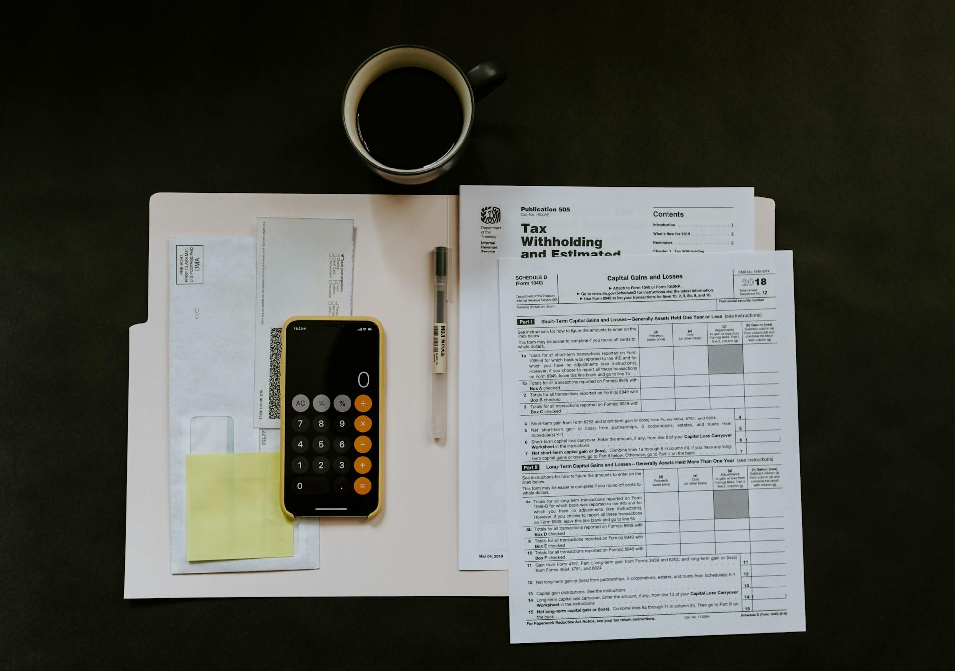tax documents and calculator on iphone